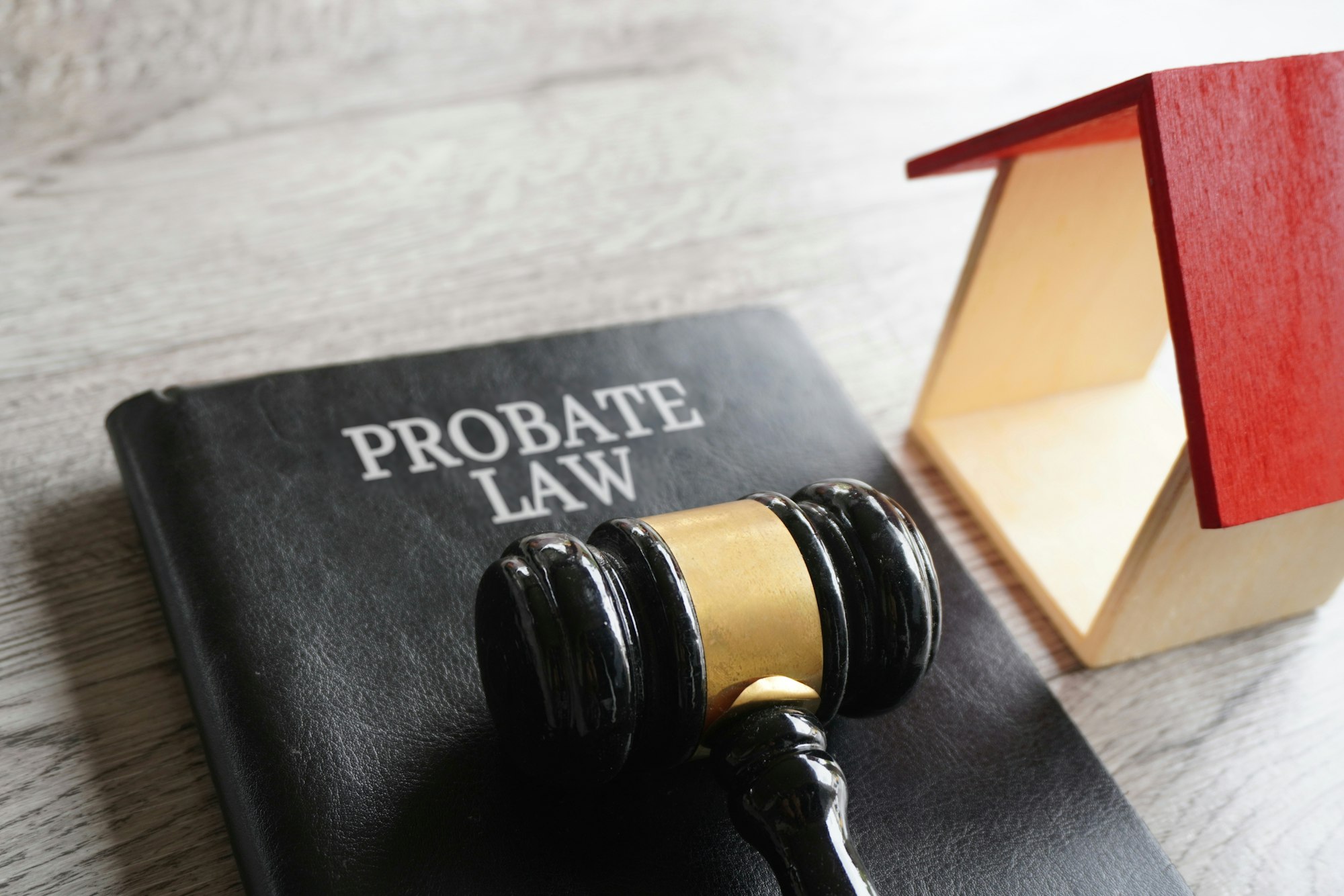 Toy house, gavel and text PROBATE LAW.